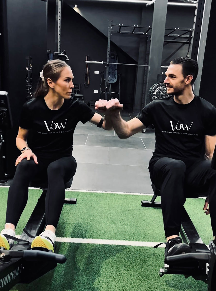The coaches are posing at the gym.